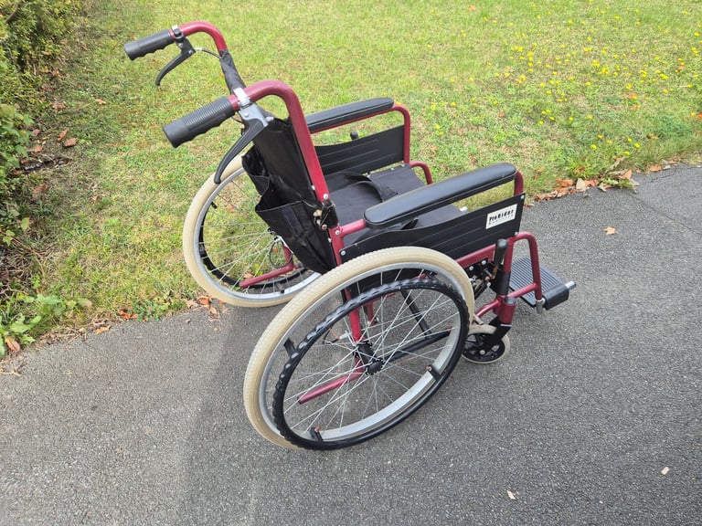Self propel wheelchair. Brakes on handle. Lap belt. Wheel chair