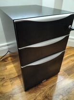 Black and grey metal filing cabinet drawers