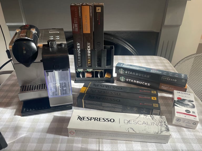 Nespresso DeLonghi coffee machine + milk frother + pods + stand