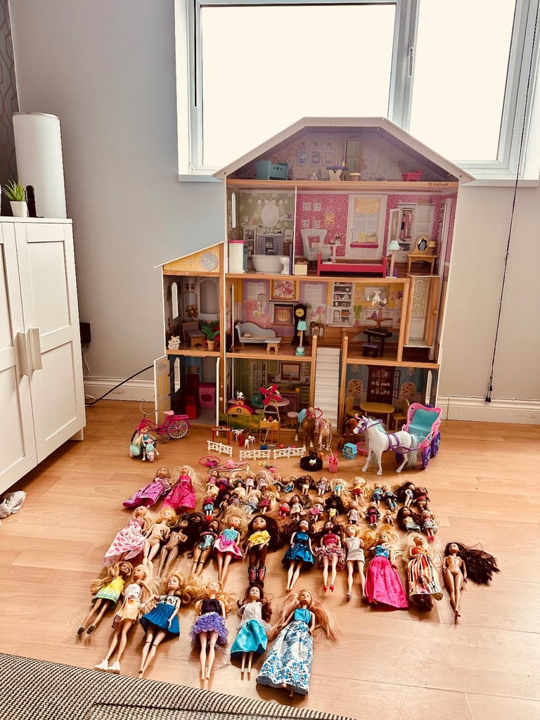 Large dolls house with dolls and accessories 