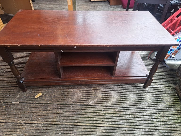 old dark wood tv stand with cupboard in the middle 