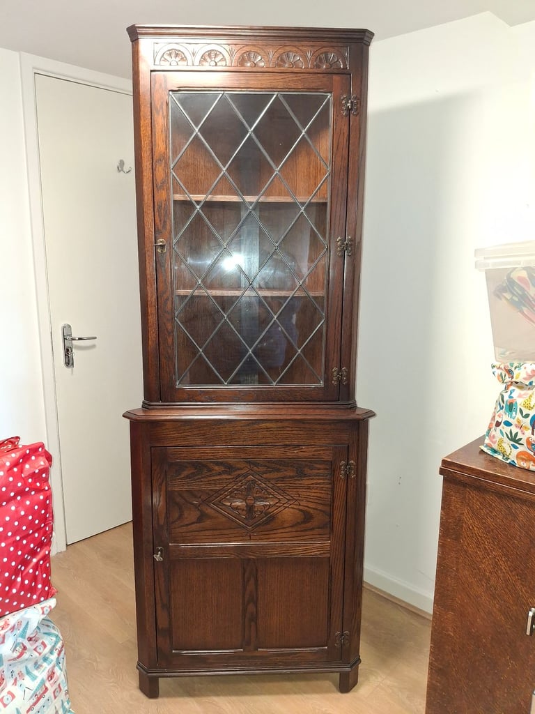 The Jaycee Vintage Oak Corner Display Cabinet is used but in very good condition.