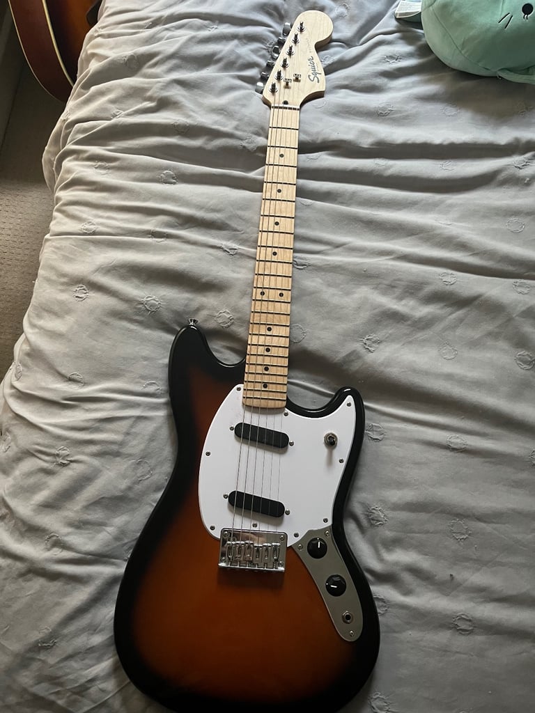 Squier by fender mustang electric guitar in sunburst