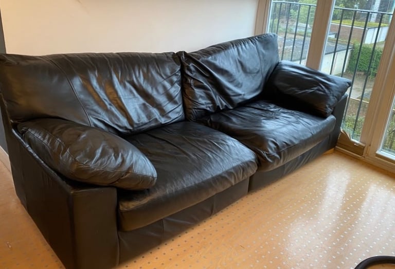 image for A faux leather sofa in the colour black
