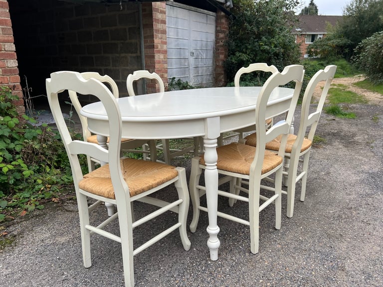 M&S Dining Table - Cream with wicker chairs. six chairs and an extender