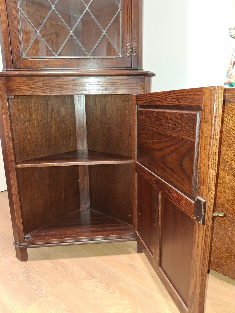 The Jaycee Vintage Oak Corner Display Cabinet is used but in very good condition.