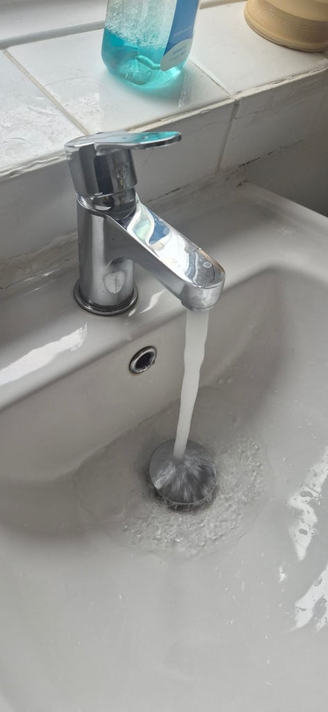 Basin with mixer tap .