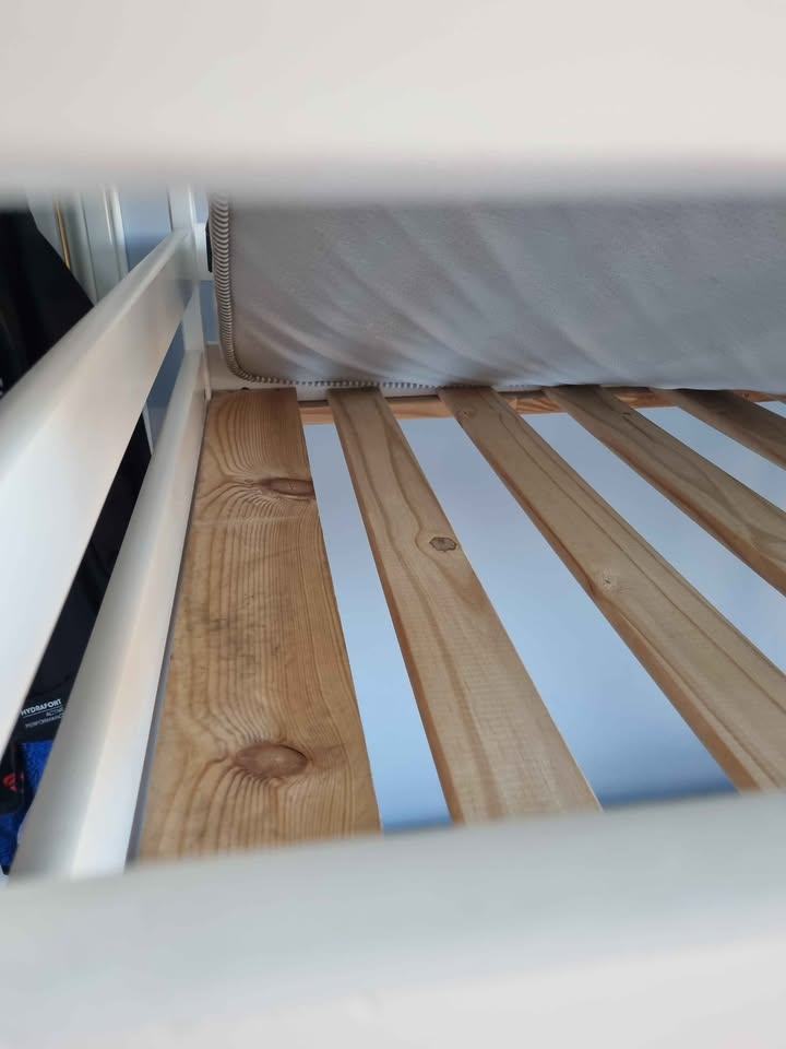 White wooden framed bunk beds with mattresses