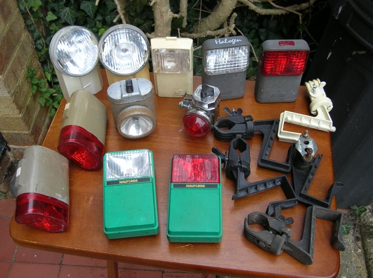 Collection of vintage front and rear bicycle lights.