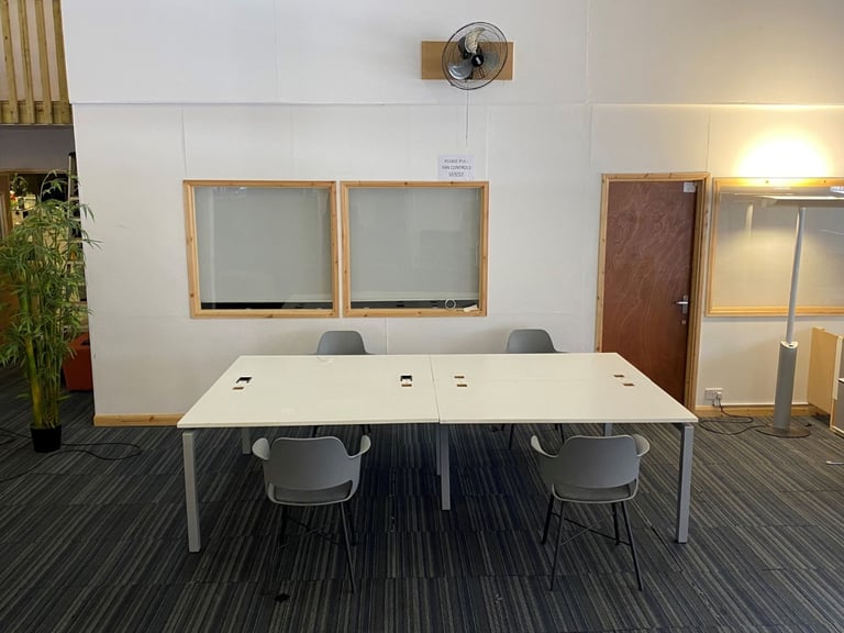 White bank of 4 used office bench desks 1400mm per desk