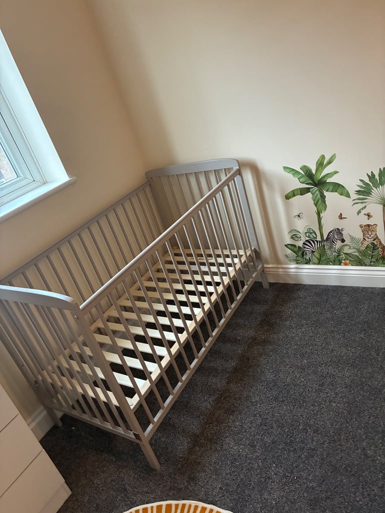 Brand new - grey cot. With side protectors