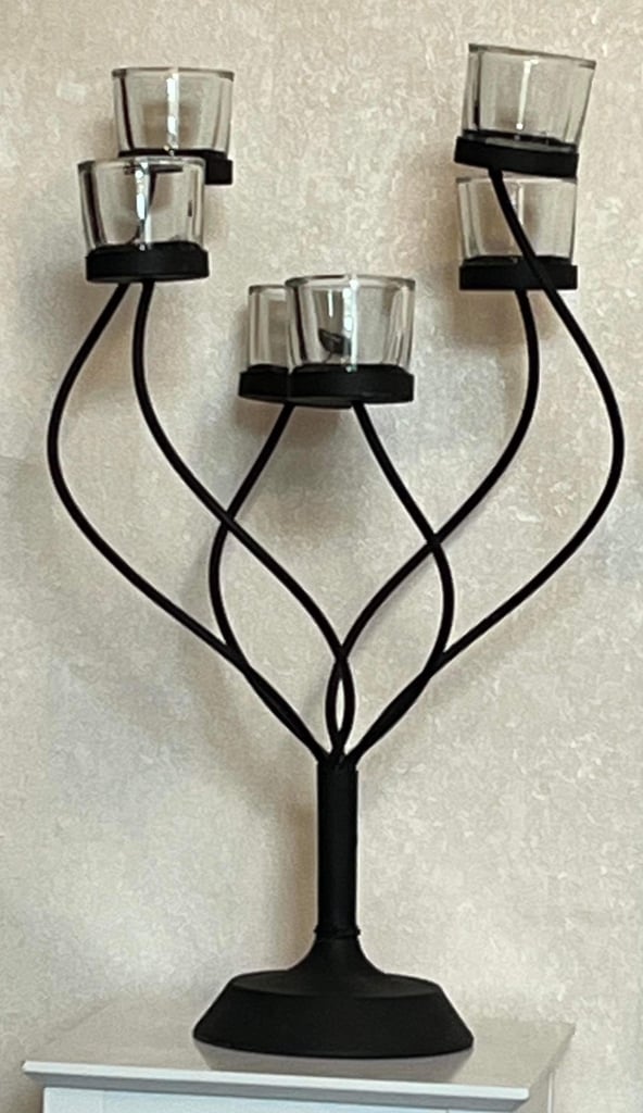 Metal candle holder with glass tea light holders. 