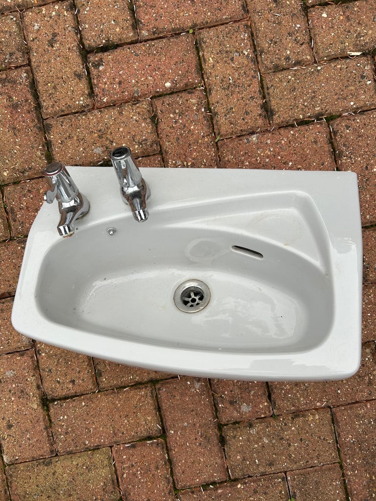 Small grey cloakroom basin sink with taps