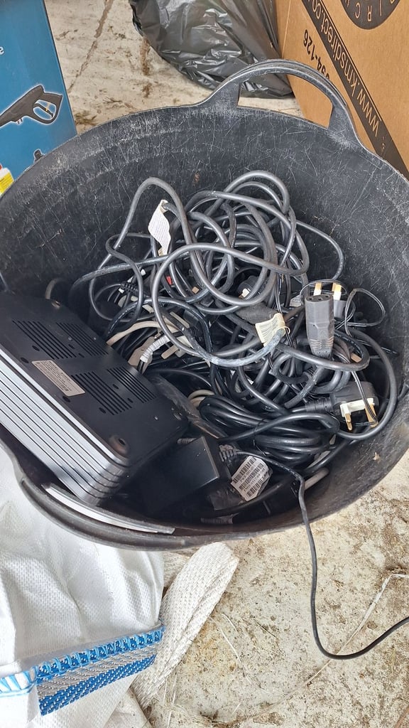 Tub of old computer wires and power units