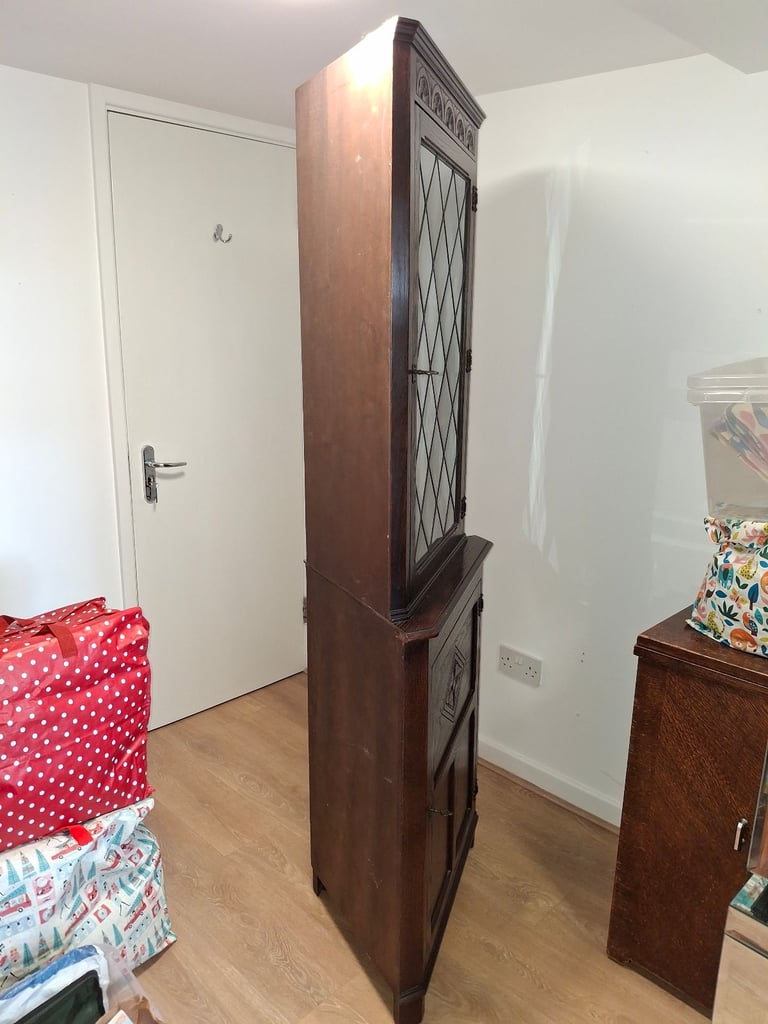 The Jaycee Vintage Oak Corner Display Cabinet is used but in very good condition.