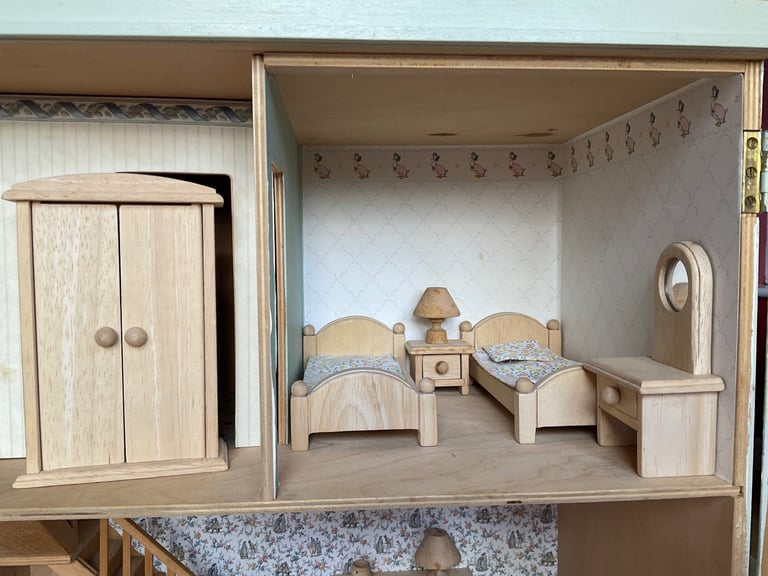 Handmade wooden dolls house with furniture and family