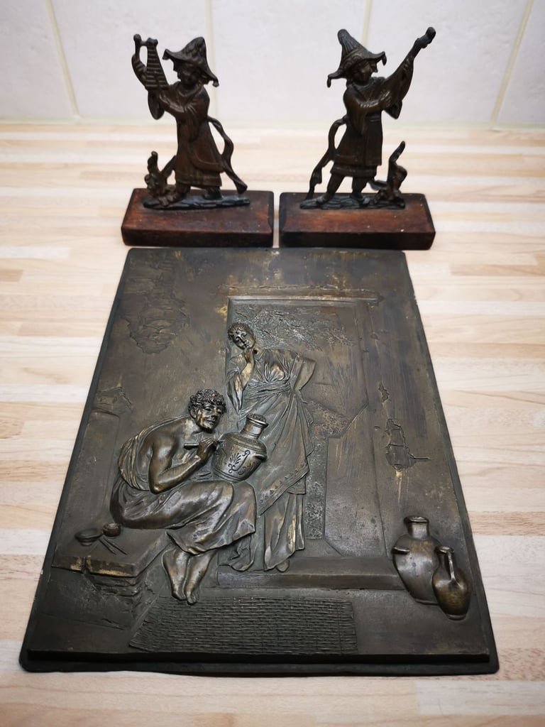 Two mounted bronze 19th Century musician ornaments with a metal plaque
