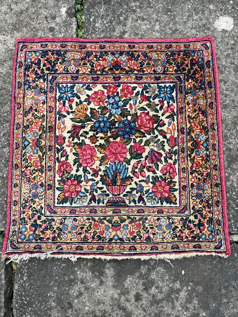A pair of Antique Kirman mats 