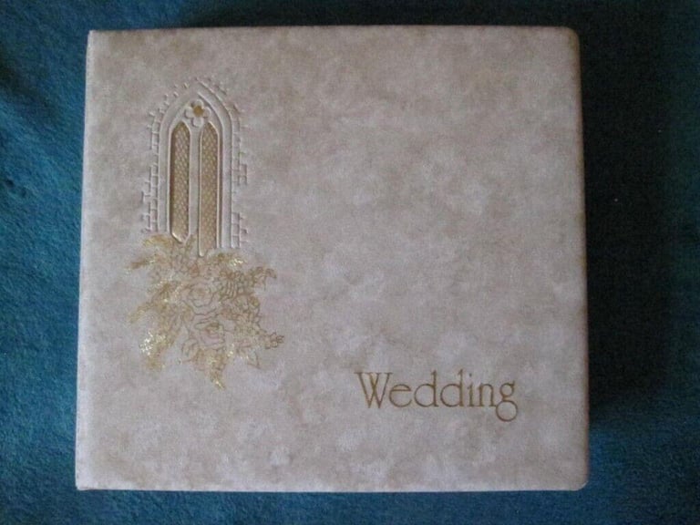 Wedding Album with gold writing, 1 corner of frame is slightly torn & photographer name on it 