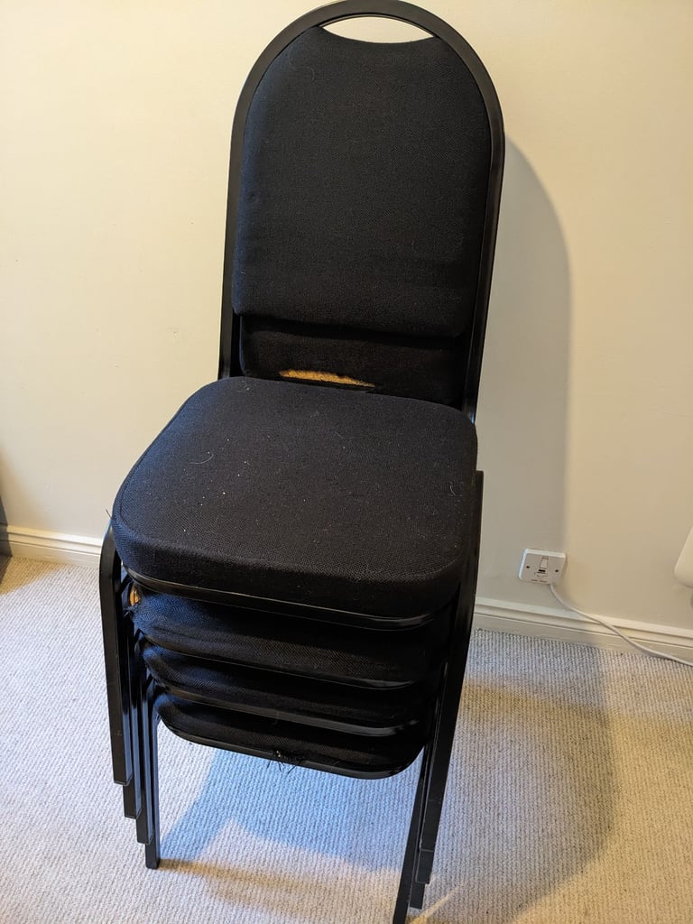 Four black office chairs - stackable 
