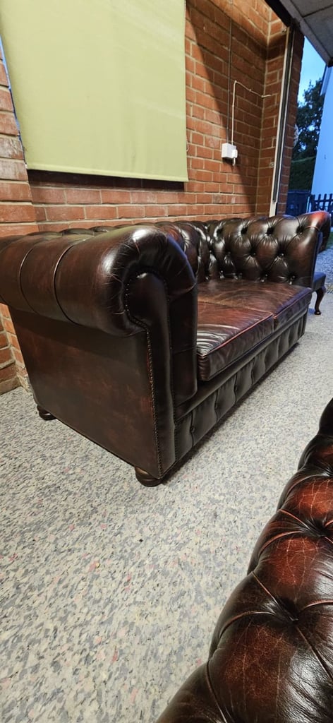 Beautiful vintage 2 seater chesterfield sofa with matching footstool.