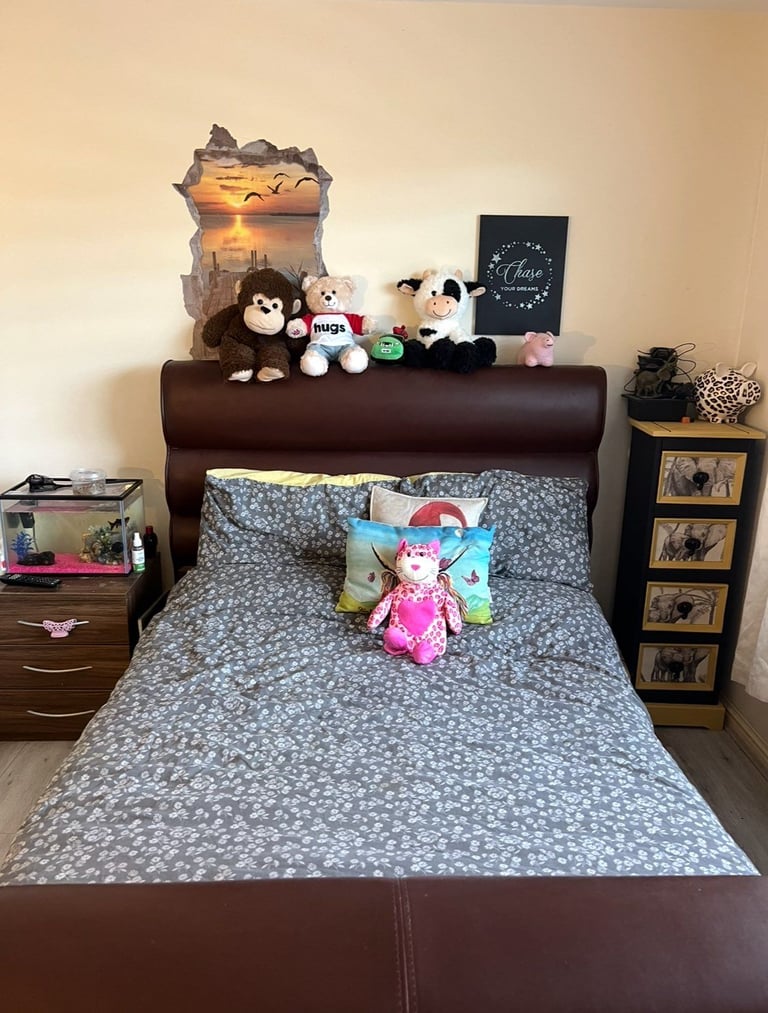 Brown leather double bed under ovening tv lift. 