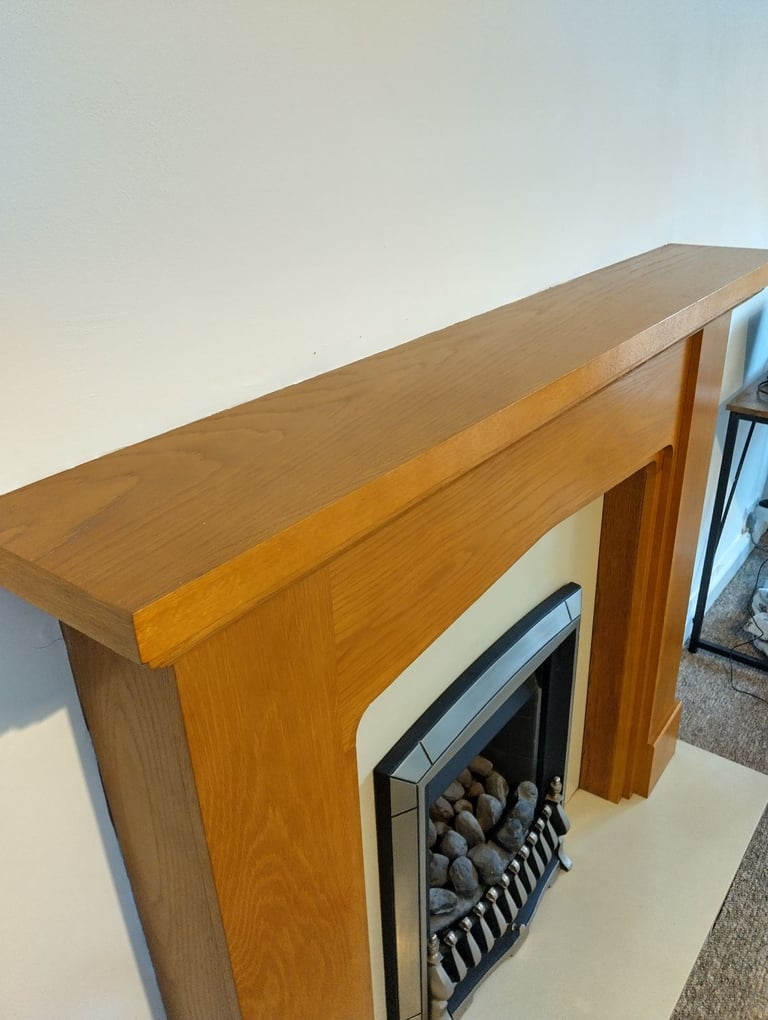 Gas fire with hearth and wood surround