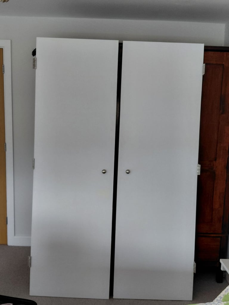Painted white wardrobe doors with hinges and handles