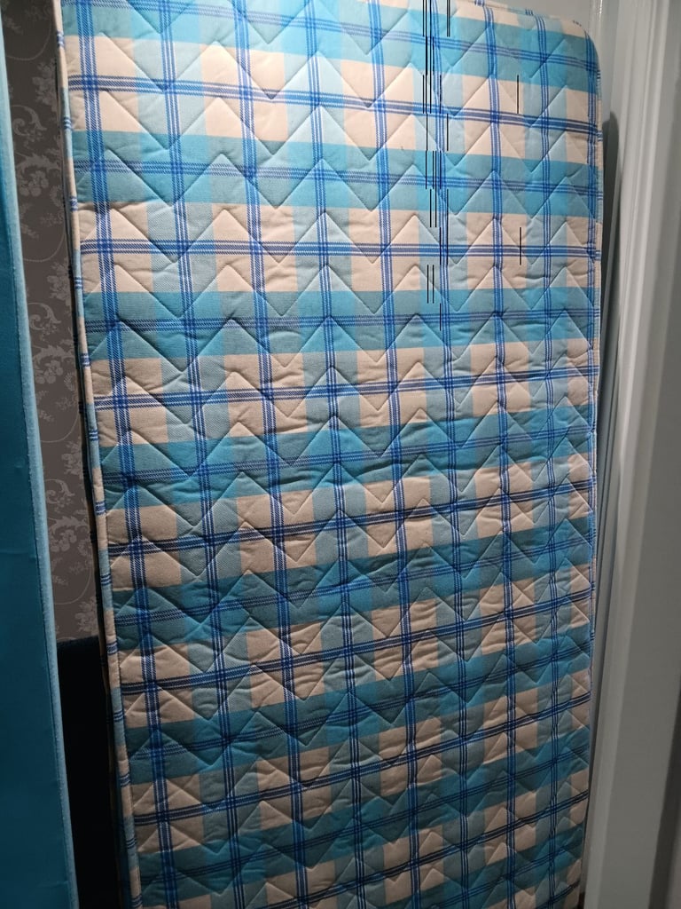 Single bed base and mattress with additional guest mattress stored underneath 