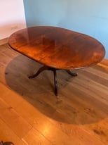 Extendable (round to oval) dark wood dining table