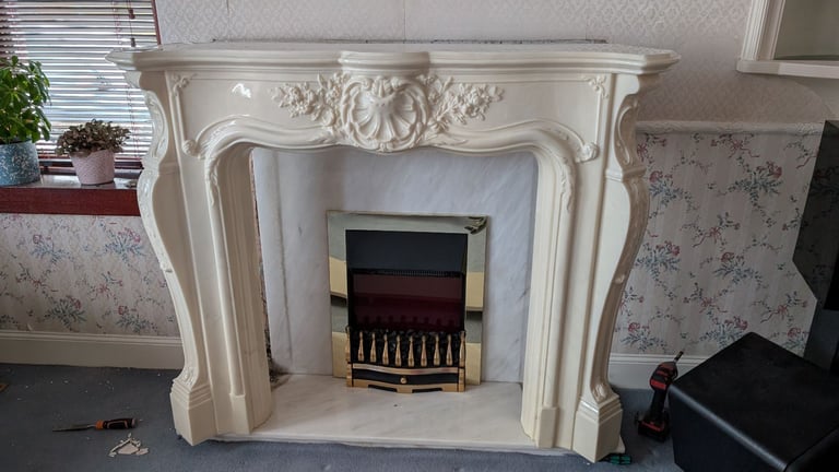 Fireplace surround with marble back and hearth.