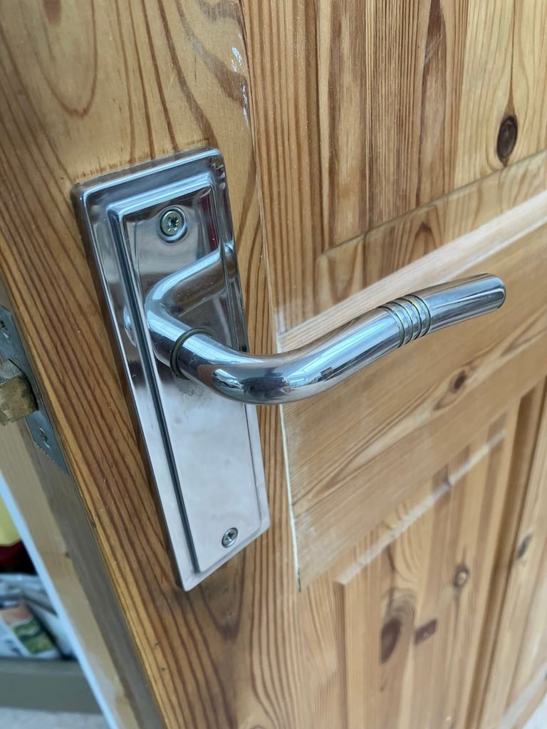 solid pine 4 panel door with silver coloured handle 