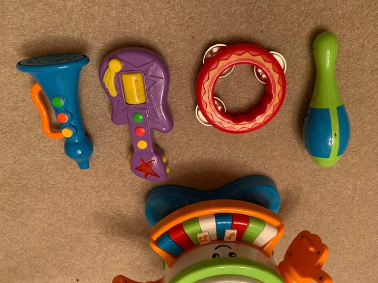 Drum, keyboard tambourine, guitar, maraca and trumpet musical toys