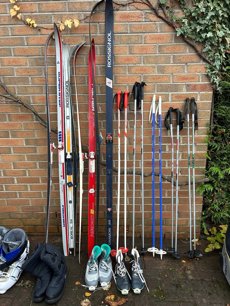 Various cross country skis, poles and boots
