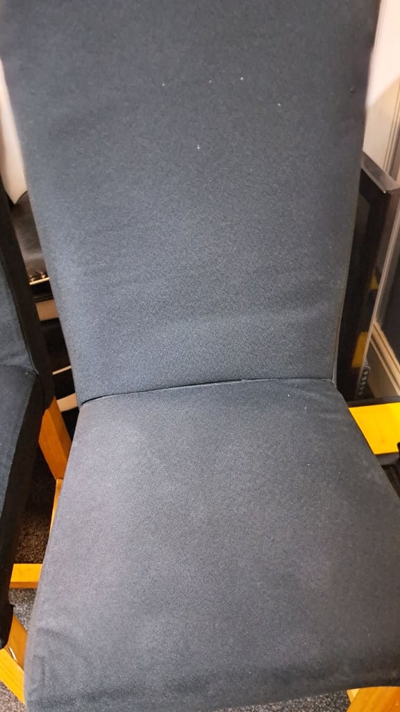 Two black solid chairs. 