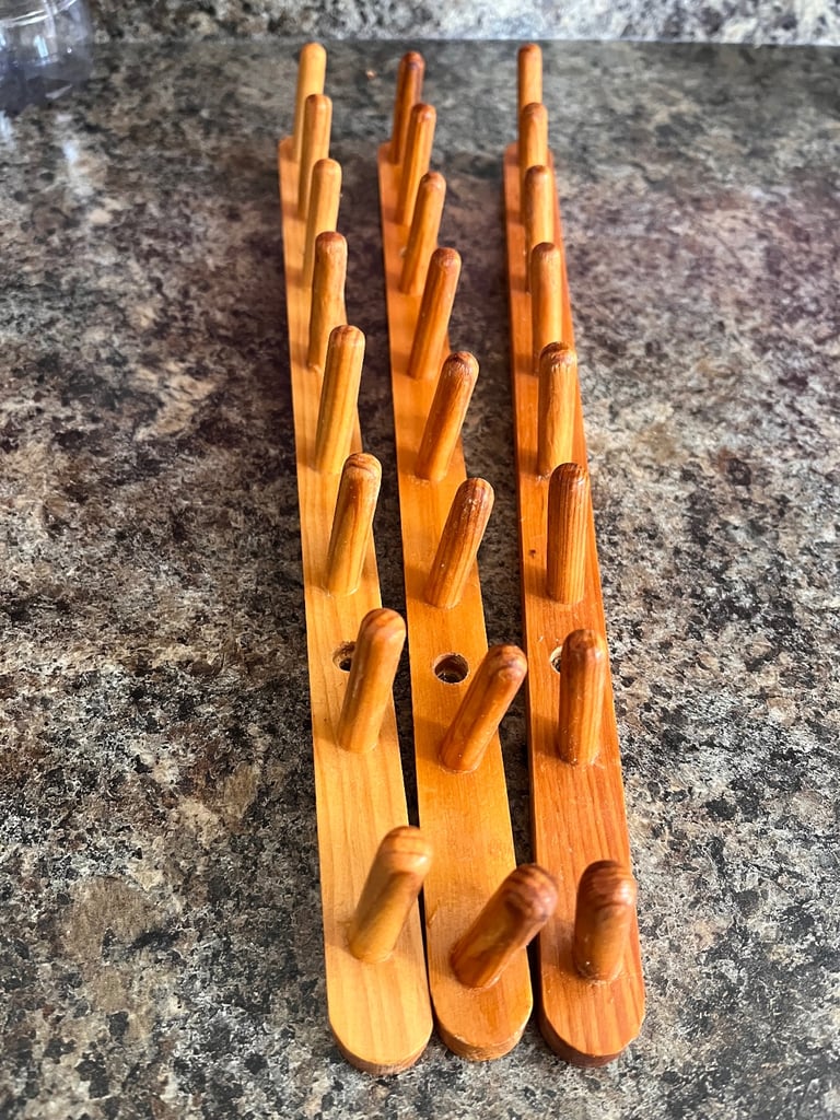 image for Set of three wooden pegs on short rail. Various uses