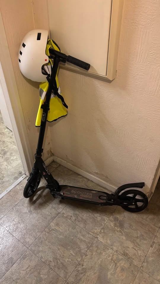 Scooter with helmet and reflective vest