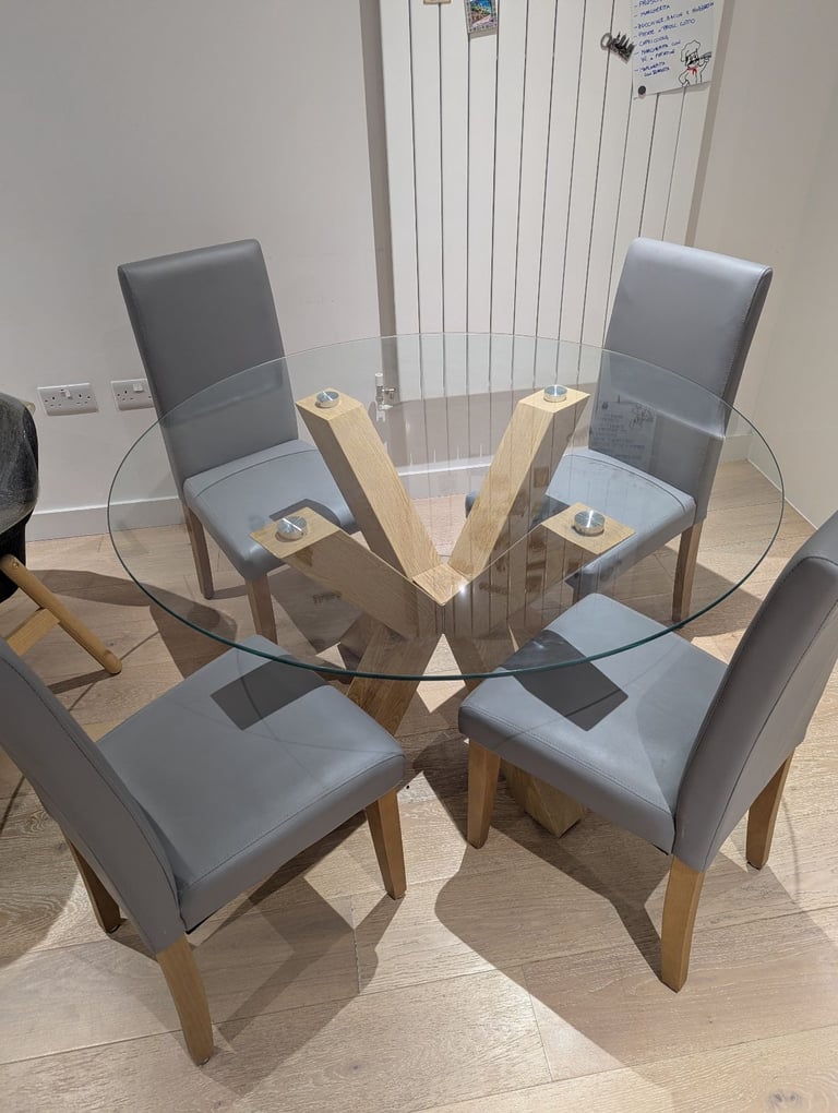 Glass round table with grey chairs