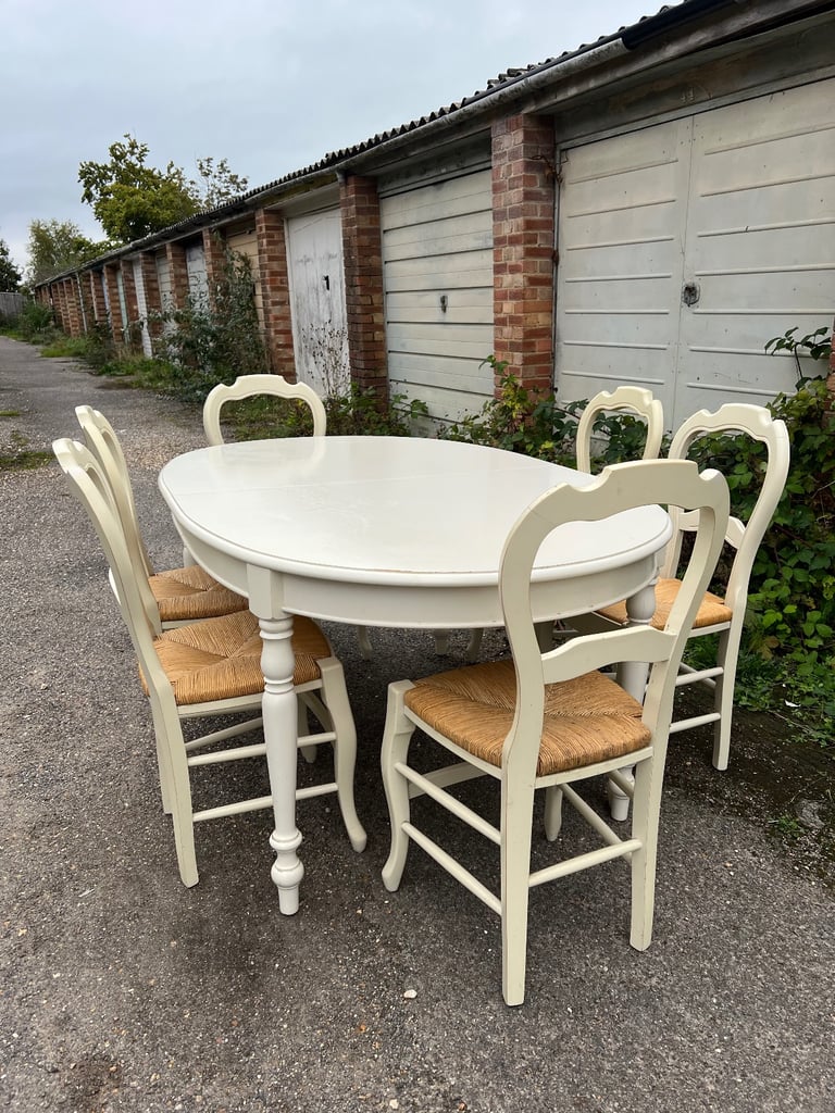 M&S Dining Table - Cream with wicker chairs. six chairs and an extender