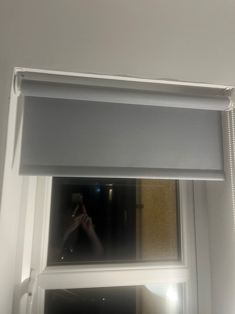 Two grey roller blinds 