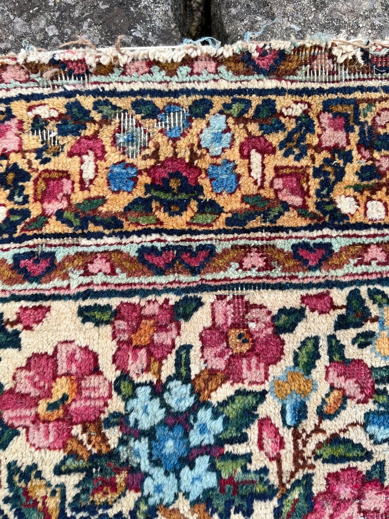 A pair of Antique Kirman mats 
