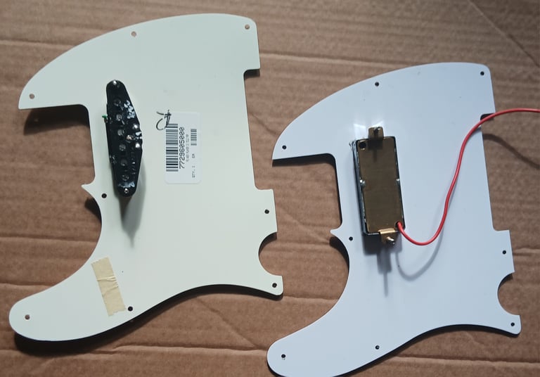 Two Telecaster pickguards with pickups