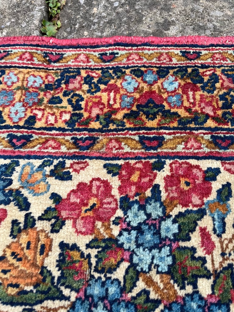 A pair of Antique Kirman mats 
