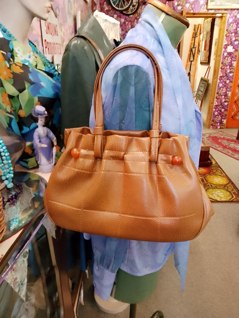 image for Vintage 1970s tan handbag. Middle bar with round plastic ball detail. Stitched pattern detail.
