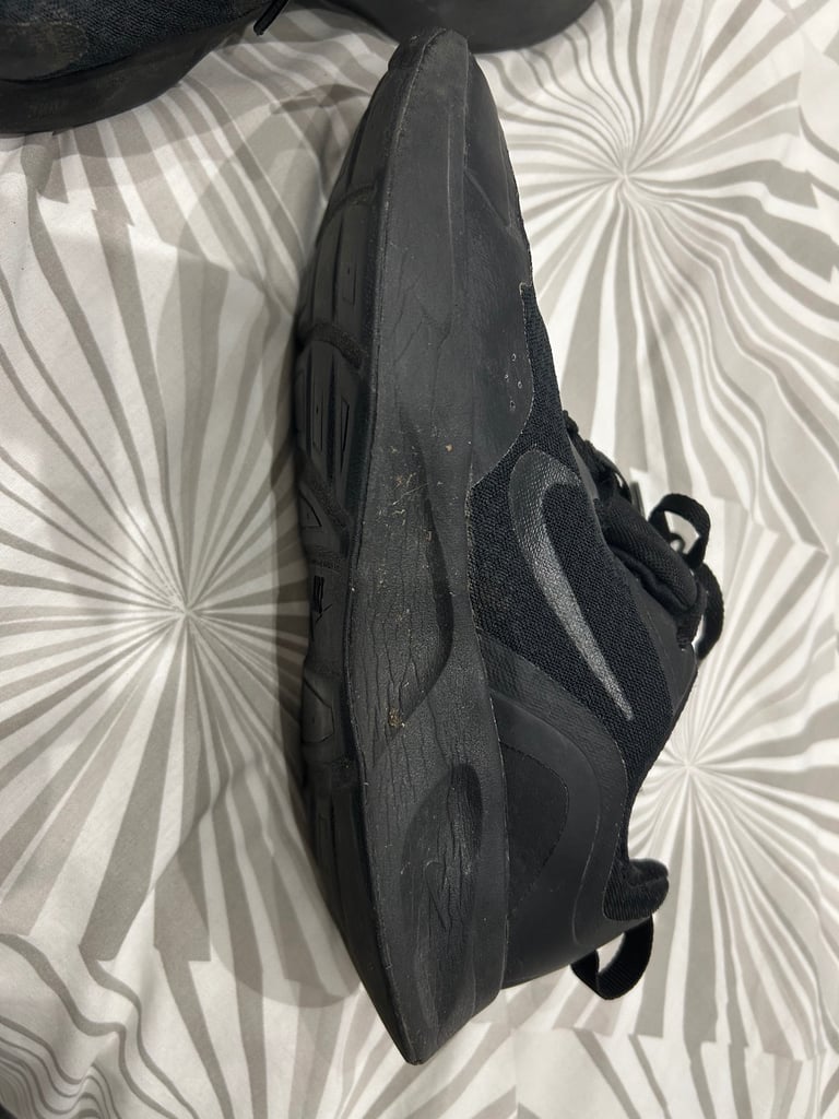 Ladies lace up Nike black trainers. Size 4