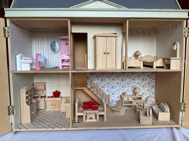 Handmade wooden dolls house with furniture and family