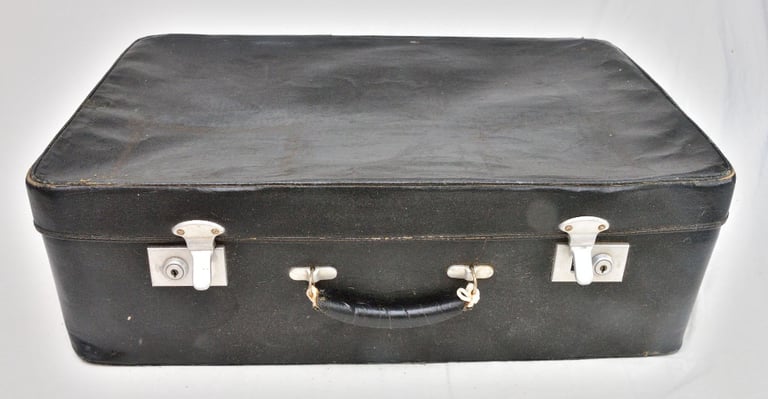 Vintage (1960s) black suitcase, well travelled and used