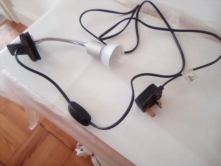 Flexible light, clips onto office desk or work bench.