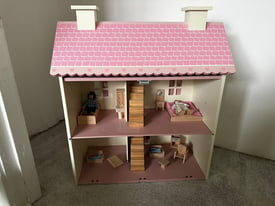 Girls pink dolls house with furniture 