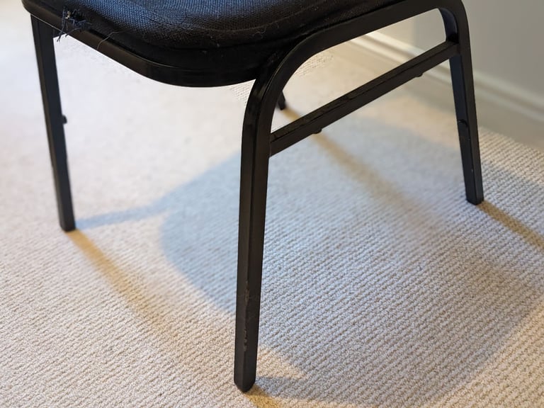 Four black office chairs - stackable 